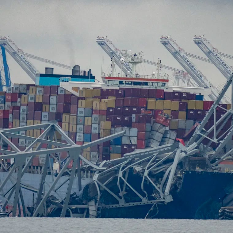 The container ship Dali, owned by Grace Ocean PTE, rests against wreckage of the Francis Scott Key Bridge in the Patapsco River on Wednesday as seen from Pasadena, Md.