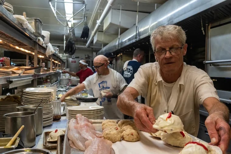 Joseph Fulton, a boiler cook and 30-year employee, preps crab imperial for the dinner rush at the Lobster House, which is celebrating its 100th year in 2022.