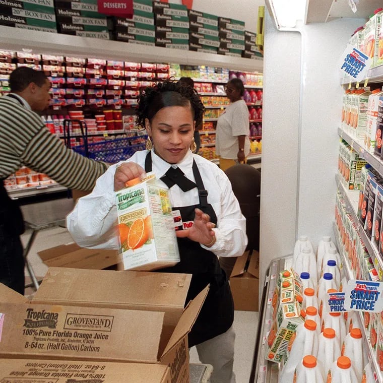 Rosa Padilla stocking the shelves at the new Pathmark in North Philadelphia in 1999.