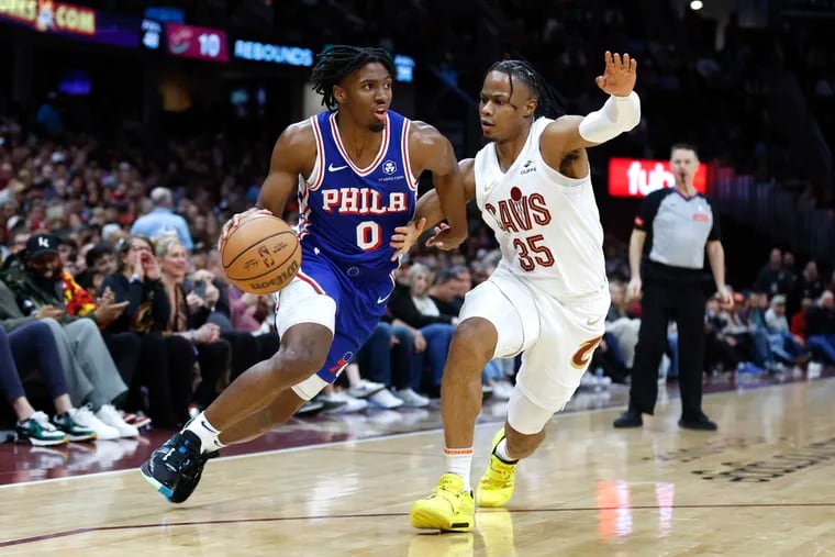 Tyrese Maxey of the Sixers driving against Cleveland Cavaliers forward Isaac Okoro on Friday.