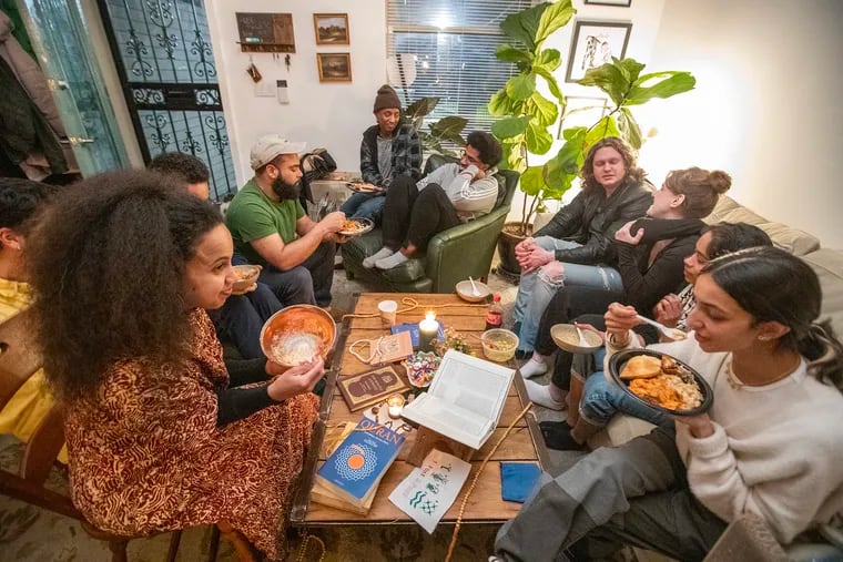 A crowded room at an iftar dinner during Ramadan on March 22. Kaamila Mohamed (front left) and Maham Rizvi (front right) were among those attending the event hosted by hosted by Queer Māʾida.