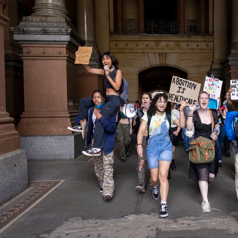 High schoolers from Philadelphia walk through the north portal of Philadelphia's City Hall to meet up with other students to protest for abortion rights on May 25, 2022.