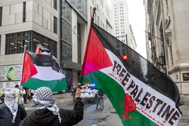 People holding Palestine flags during the march with the All Out for Gaza protest in Philadelphia on March 9. Almost 70 demonstrators were arrested in a #ShutItDown4Palestine local rally Saturday, where hundreds of demonstrators took to a portion of Interstate 676, blocking traffic, police said.