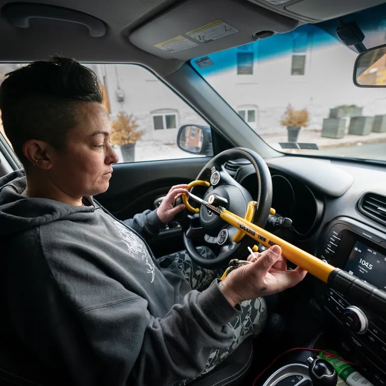 Amy Nieves-Renz shown here in January 2023 with “The Club,” a steering wheel device that she uses to safeguard her vehicle. Her car was stolen in November 2022 as a result of what police said was a TikTok trend.