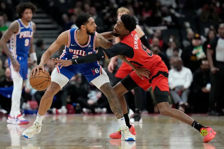 Sixers guard Cameron Payne searches for an opening  as he keeps Toronto Raptors guard Kobi Simmons at bay.