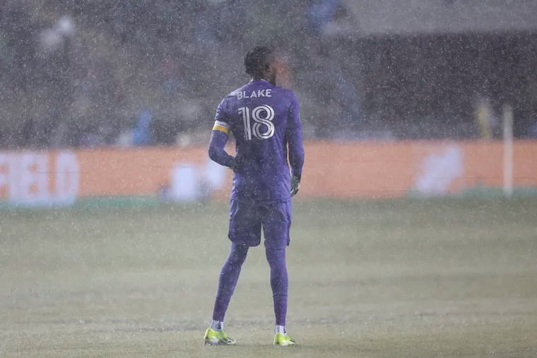 Goalkeeper Andre Blake standing in the rain before the Union-Sounders game was postponed because of a waterlogged field on March 9.